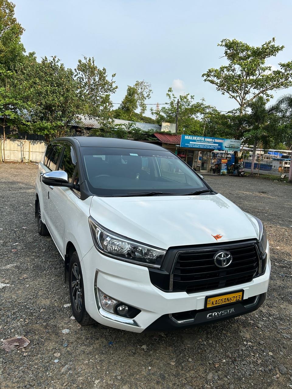 Toyota Innova Crysta parked outdoors white cab